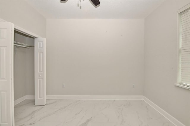 unfurnished bedroom featuring a closet and ceiling fan