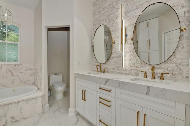 bathroom with a relaxing tiled tub, vanity, and toilet