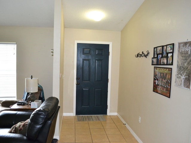 tiled foyer with vaulted ceiling