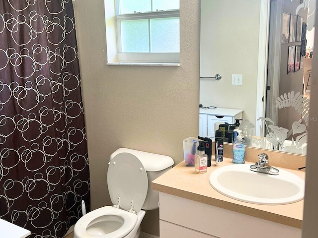 bathroom featuring vanity and toilet