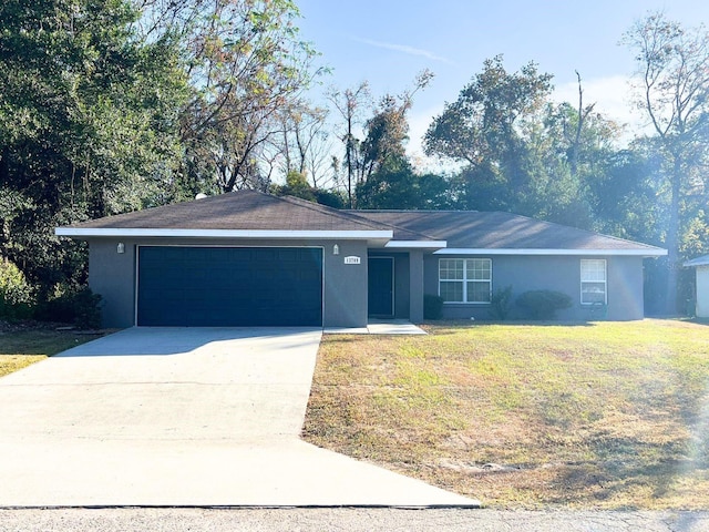 ranch-style home featuring a garage and a front yard