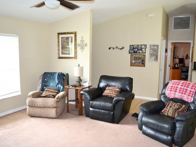 carpeted living room with vaulted ceiling and ceiling fan