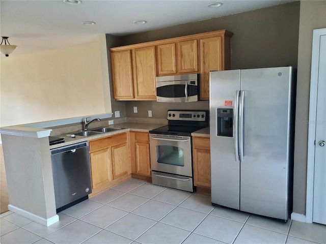 kitchen with sink, appliances with stainless steel finishes, and light tile patterned flooring