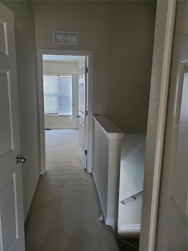 corridor with light colored carpet