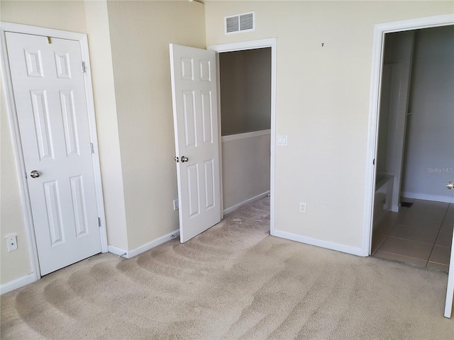 unfurnished bedroom featuring light colored carpet