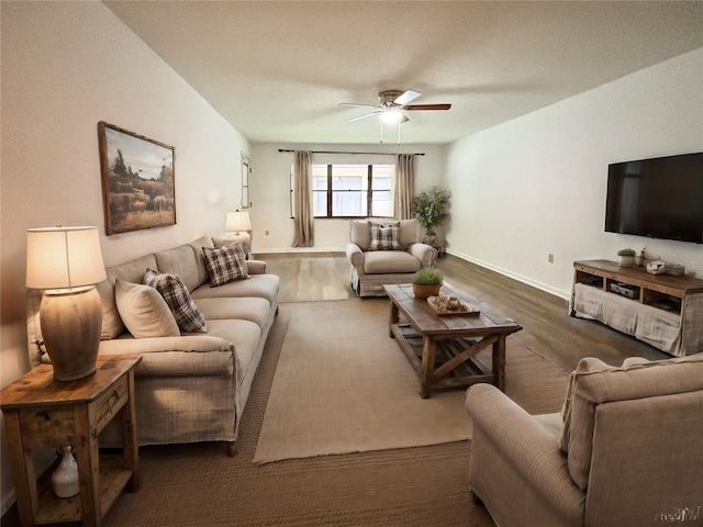 living room with dark hardwood / wood-style flooring and ceiling fan