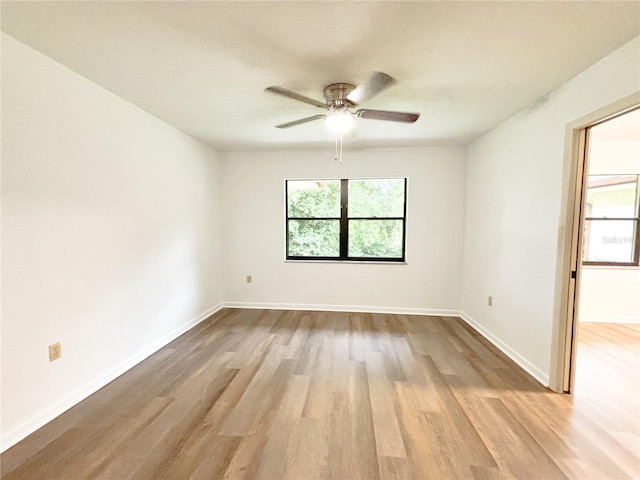 unfurnished room with ceiling fan and wood-type flooring