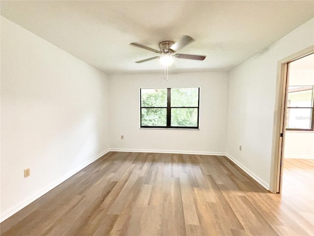 21389 SW 102nd Street Rd, Dunnellon, FL 34431 - unfurnished room with wood finished floors, baseboards, and ceiling fan