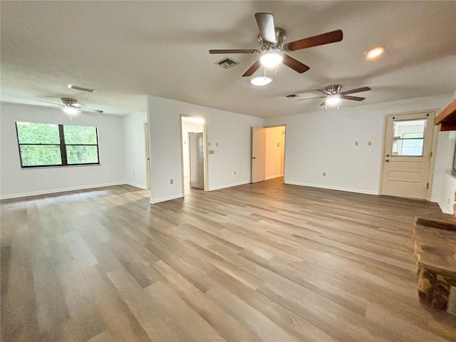21389 SW 102nd Street Rd, Dunnellon, FL 34431 - unfurnished living room with visible vents, baseboards, wood finished floors, and a ceiling fan