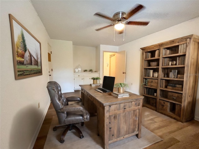 home office with ceiling fan and a textured ceiling