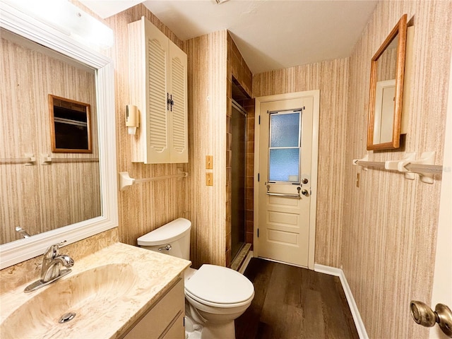 bathroom featuring vanity, toilet, hardwood / wood-style flooring, and an enclosed shower