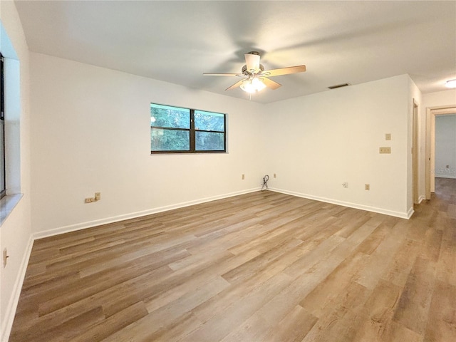 21389 SW 102nd Street Rd, Dunnellon, FL 34431 - spare room with visible vents, baseboards, a ceiling fan, and wood finished floors
