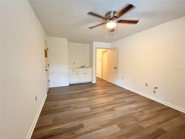 unfurnished bedroom featuring ceiling fan and wood-type flooring