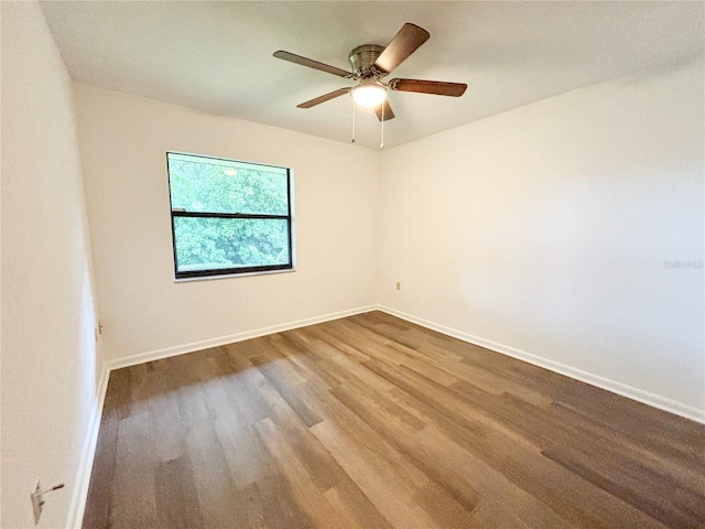 spare room with ceiling fan and hardwood / wood-style flooring