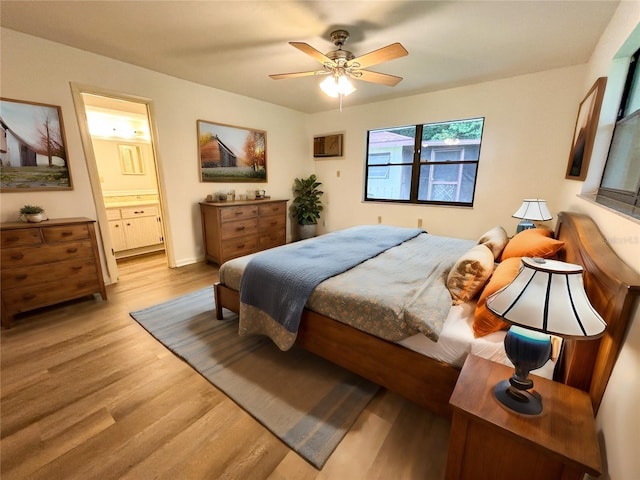 bedroom with ceiling fan, hardwood / wood-style flooring, and ensuite bath