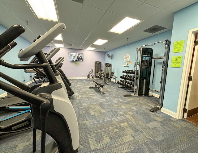 workout area featuring carpet flooring and a drop ceiling