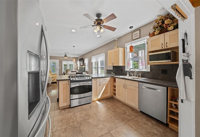 kitchen with ceiling fan, decorative light fixtures, appliances with stainless steel finishes, and a wealth of natural light