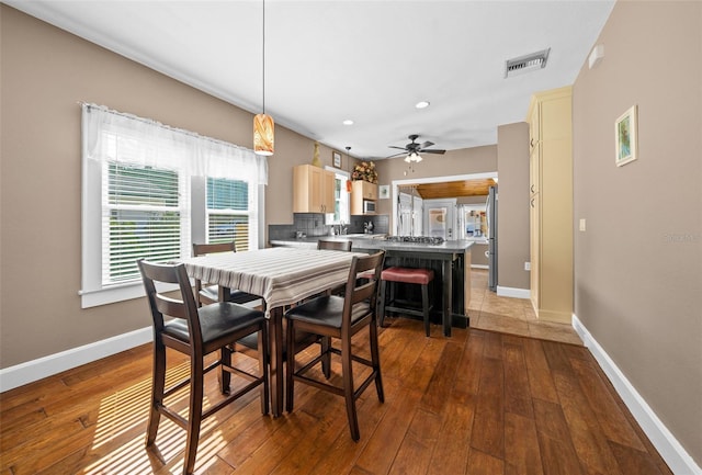 dining room featuring wood-type flooring and ceiling fan