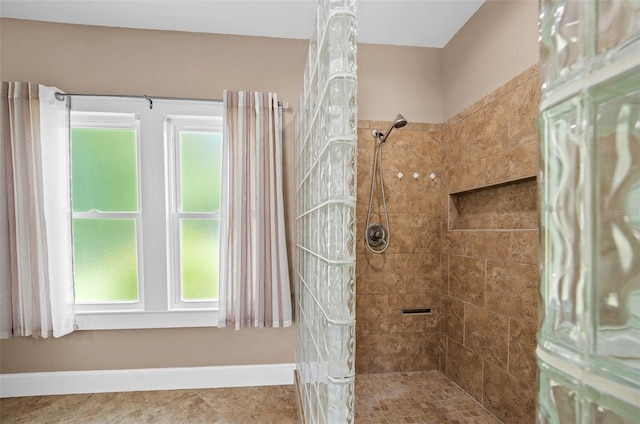 bathroom with tiled shower