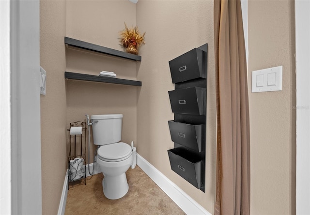 bathroom featuring toilet and tile patterned floors