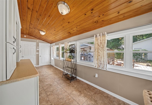 interior space featuring wood ceiling, vaulted ceiling, light tile patterned floors, and a wealth of natural light