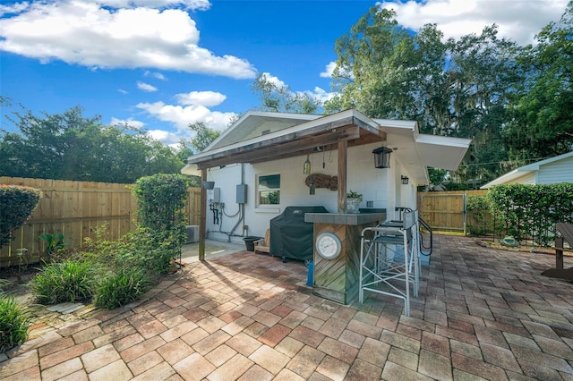 view of patio / terrace featuring a grill and a bar