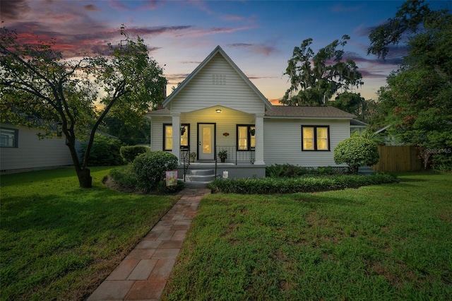 view of front of property featuring a lawn and a porch