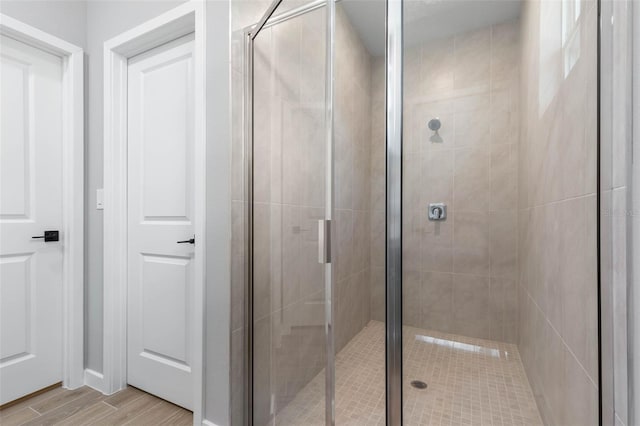 bathroom with a shower with door