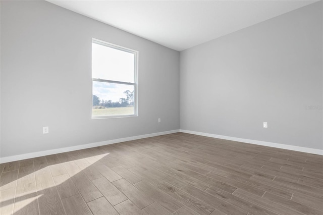 spare room with wood-type flooring