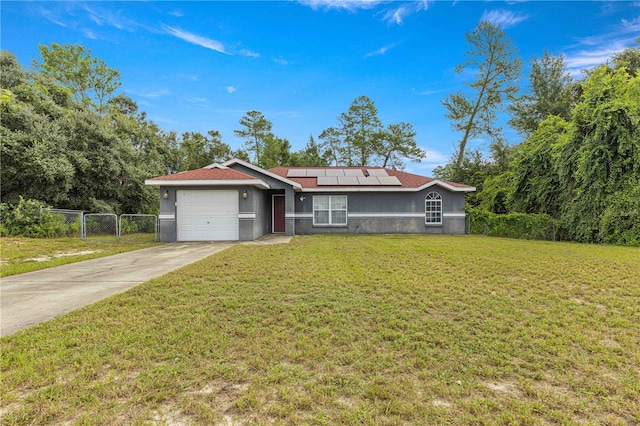 single story home with solar panels, a garage, and a front lawn