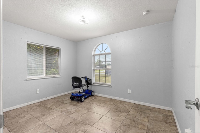 workout room with a textured ceiling