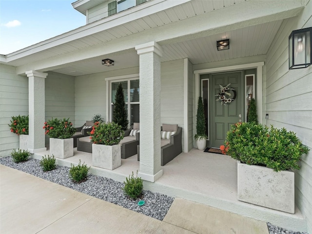 view of exterior entry with a porch