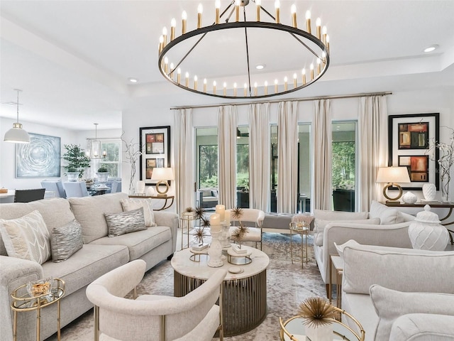 living room featuring a wealth of natural light and an inviting chandelier