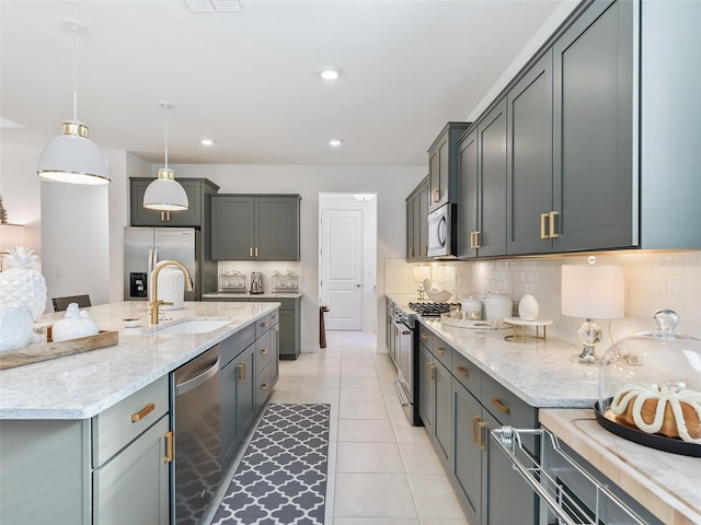 kitchen featuring gray cabinets, pendant lighting, stainless steel appliances, sink, and light tile patterned flooring