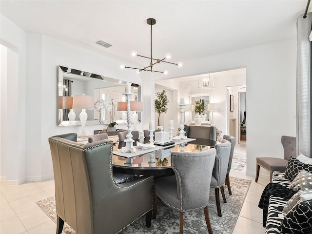 tiled dining area with a chandelier