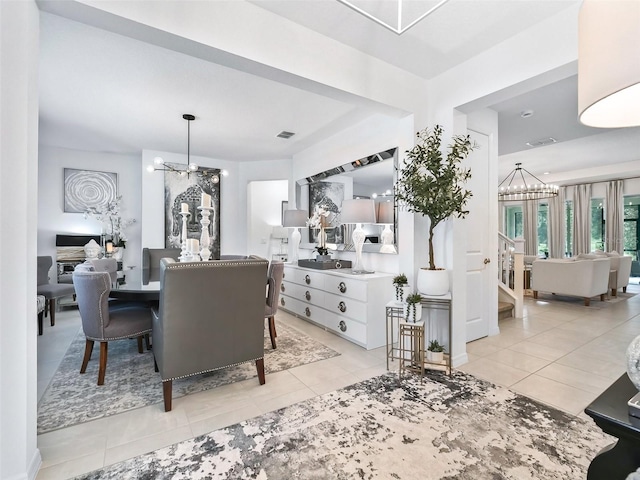 dining area with an inviting chandelier and light tile patterned flooring