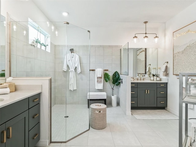 bathroom featuring vanity, tile walls, a shower with shower door, and tile patterned floors