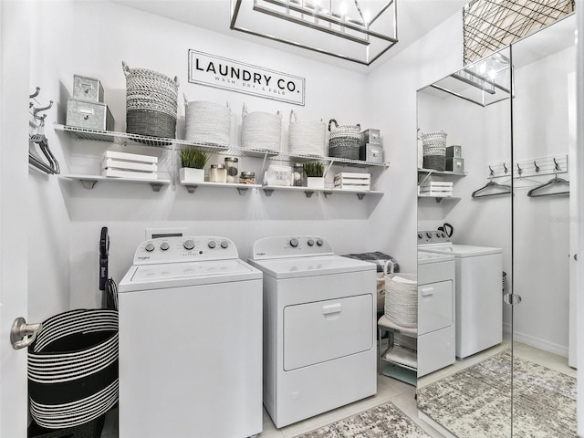 laundry room with independent washer and dryer and light tile patterned floors