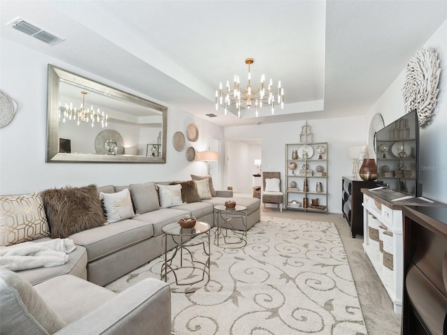 living room featuring a raised ceiling and an inviting chandelier