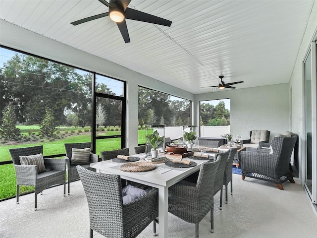 sunroom / solarium featuring a healthy amount of sunlight and ceiling fan