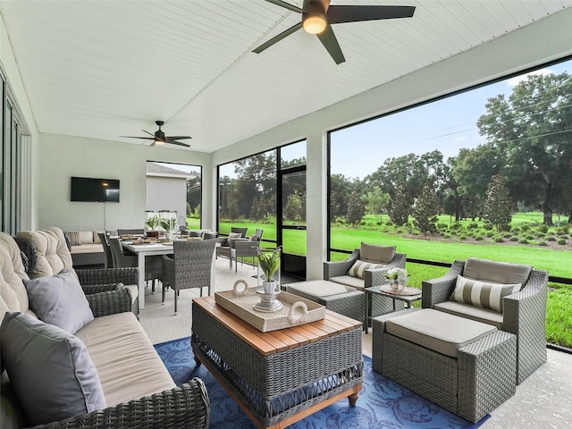 sunroom / solarium featuring ceiling fan