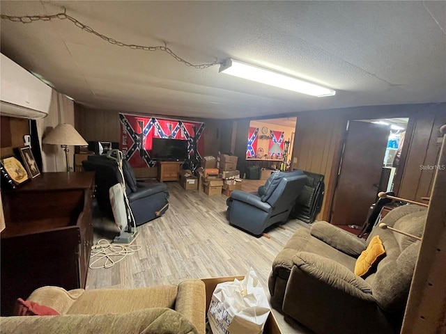 living room with a textured ceiling and light hardwood / wood-style flooring