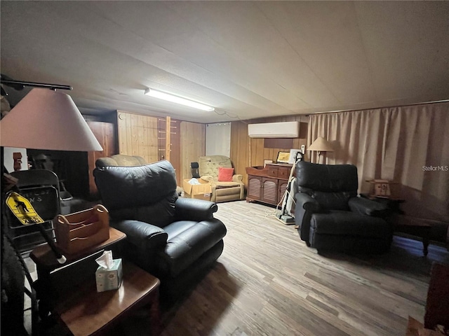 living room with a wall mounted AC and hardwood / wood-style floors