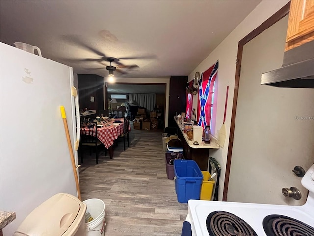 interior space with white refrigerator and hardwood / wood-style flooring