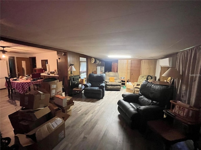 living room featuring wood walls and hardwood / wood-style floors