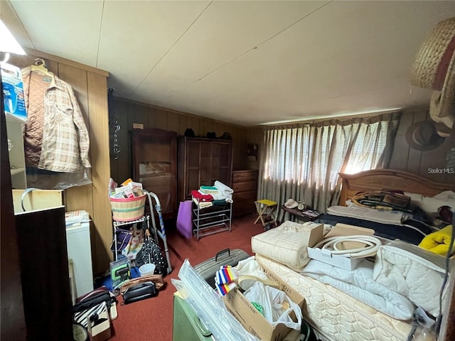 carpeted bedroom featuring wooden walls