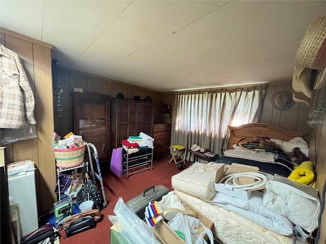 bedroom featuring carpet and wood walls