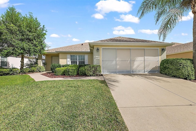 view of front of property with stucco siding, driveway, a front lawn, an attached garage, and a shingled roof