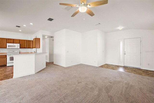 unfurnished living room featuring ceiling fan, carpet floors, and vaulted ceiling