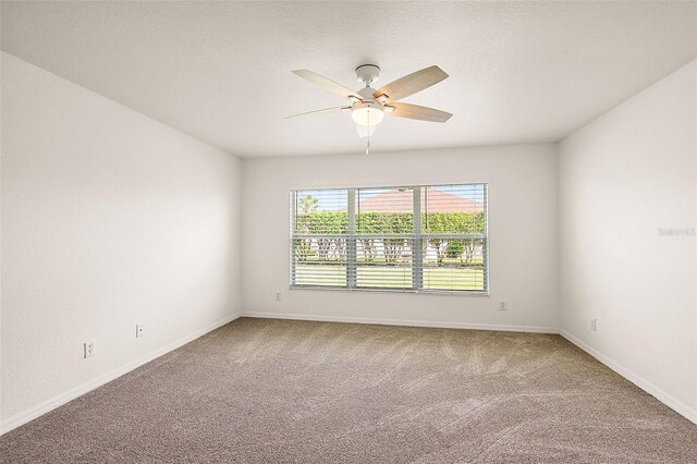 unfurnished room featuring a textured ceiling, carpet, and ceiling fan